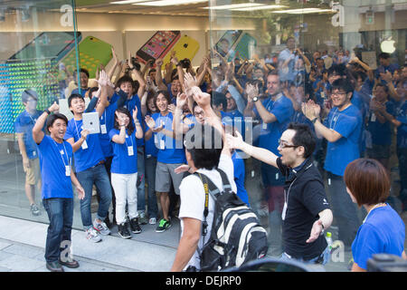 Staff welcome customers into the Apple store in Covent Garden, London ...
