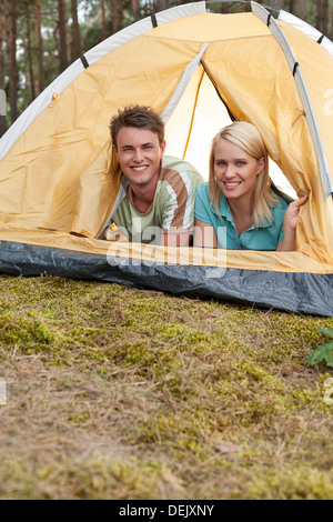 Portrait happy young couple lying tent Stock Photo