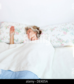 Senior woman sleeping bed home Stock Photo