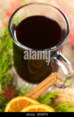 Hot mulled wine with spices and evergreen (Selective Focus, Focus on the front rim of the glass) Stock Photo