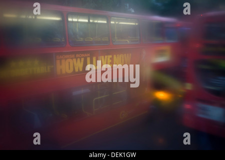 Seen through upper-deck window condensation, buses and traffic during damp, gloomy weather in central London. Stock Photo