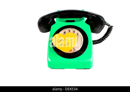 Old rotary phone with note saying call mom Stock Photo