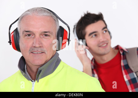 Happy builder wearing ear protection Stock Photo - Alamy