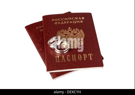 Isolated pair of wedding rings on Russian passports with clipping, path Stock Photo