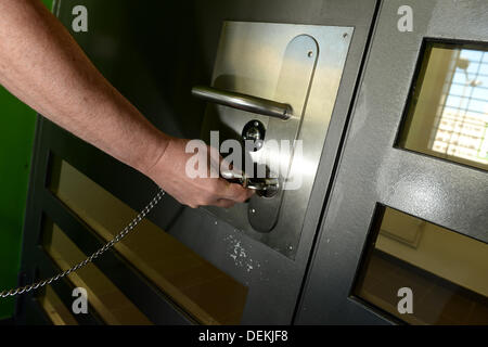 Ravensburg, Germany. 19th Sep, 2013. An employee of the prison unlocks a door in the new build of the prison in Ravensburg, Germany, 19 September 2013. Photo: Felix Kaestle/dpa/Alamy Live News Stock Photo