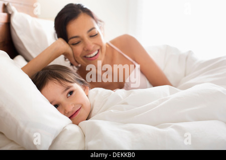 Mother and daughter laying in bed Stock Photo