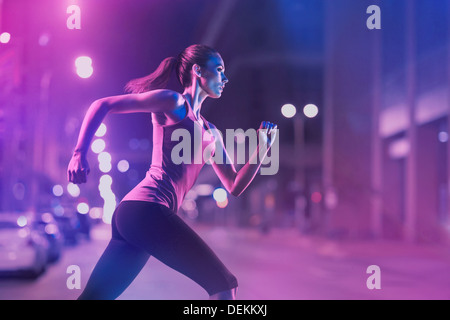 Caucasian woman running on city street Stock Photo