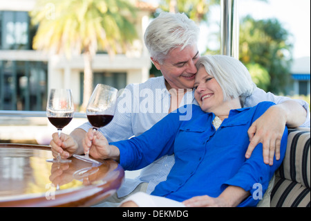 Older Caucasian couple having wine together on boat Stock Photo
