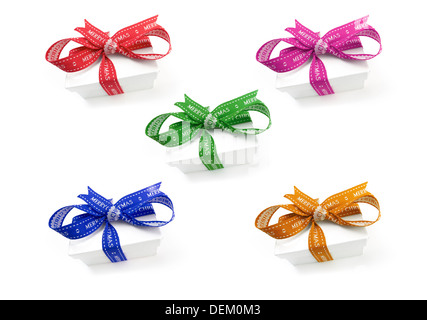 A selection of wrapped Christmas presents with a colourful ribbons and bows on a white background. Stock Photo