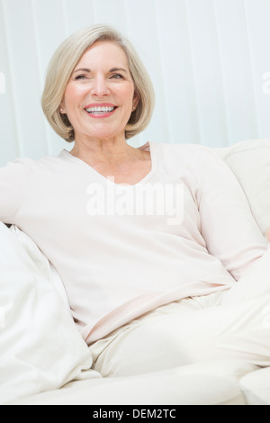 Portrait of an attractive elegant senior woman relaxing at home. Stock Photo