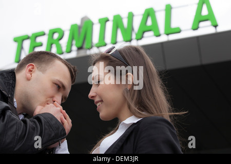 Two people in the airport. Man kissing woman's hand Stock Photo