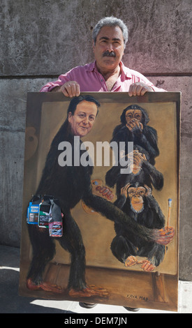 Artist Kaya Mar poses with one of his paintings, London, England, United Kingdom Stock Photo