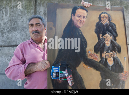 Artist Kaya Mar poses with one of his paintings, London, England, United Kingdom Stock Photo