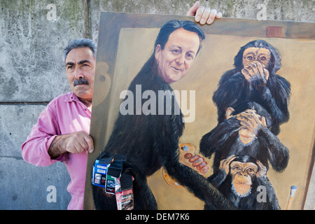 Artist Kaya Mar poses with one of his paintings, London, England, United Kingdom Stock Photo