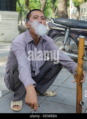 vietnam pipe tobacco A man smokes tobacco from a pipe, Hanoi, Vietnam, South East Asia Stock  Photo