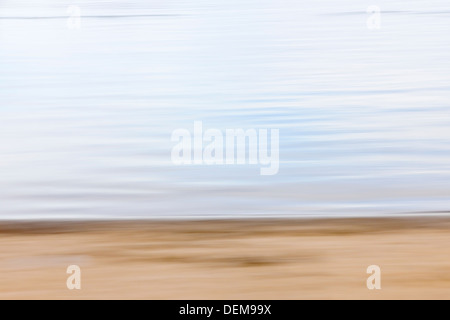 Background image of sand and water created by horizontal in-camera motion blur Stock Photo