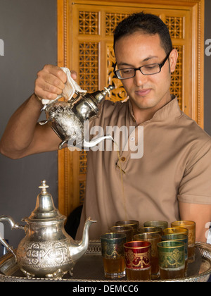 Young man in glasses and pot with recycle sign on table Stock Photo - Alamy