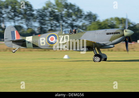 Supermarine Spitfire Mark IX MH434 taking off to display from a grass airfield. MH434 has starred in many films and on tv. Second World War plane Stock Photo