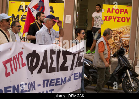Nikaia, Athens, Greece, September 21st 2013. Following Pavlos Fyssas stabbing to death by a member of the neo-nazi, Golden Dawn party, Union members and leftists stage a demonstration  to protest against fascists. The anti-fascism march passes by a pawn shop. Credit:  Nikolas Georgiou / Alamy Live News Stock Photo