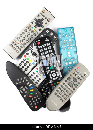 Pile of remote controls cut out isolated on white background Stock Photo