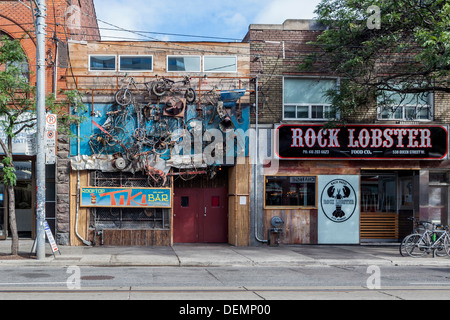 Tiki Bar - with a quirky and colourful exterior decorated with old bicycles and scrap and 'Rock Lobster" fish restaurant Stock Photo