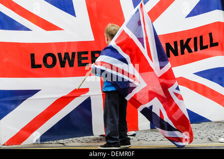 Belfast, Northern Ireland, 21st September 2013 - A young boy holds a union flag over his shoulder as he looks at a much larger one which says 'Lower Shankill' Credit:  Stephen Barnes/Alamy Live News Stock Photo