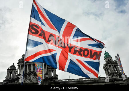 Belfast, Northern Ireland, 21st September 2013 - Union Flag with 'Sandy Row' across the middle is waved in front of Belfast City Hall Credit:  Stephen Barnes/Alamy Live News Stock Photo
