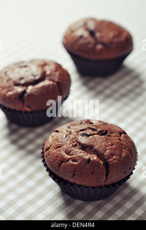 Chocolate Muffins on checkered tablecloth closeup Stock Photo