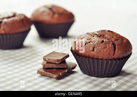 Chocolate Muffins on checkered tablecloth closeup Stock Photo