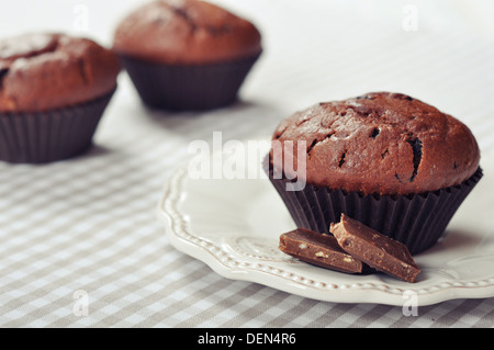 Chocolate Muffins on checkered tablecloth closeup Stock Photo