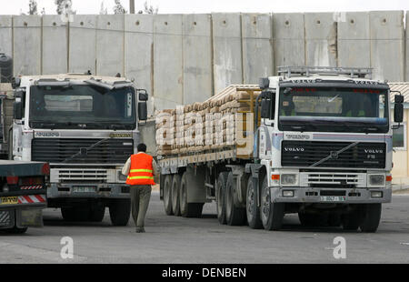 Sept. 22, 2013 - Rafah, Gaza Strip, Palestinian Territory - A Palestinian man walks near trucks loaded with cement supplies after upon arrival to the town of Rafah through the Kerem Shalom crossing between Israel and the southern Gaza September 22, 2013. Israel began allowing construction material for private projects into the Gaza Strip on Sunday for the first time in six years, in response to a request from Palestinian President Mahmoud Abbas, an Israeli defence official said  (Credit Image: © Eyad Al Baba/APA Images/ZUMAPRESS.com) Stock Photo