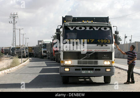 Sept. 22, 2013 - Rafah, Gaza Strip, Palestinian Territory - A Palestinian man stands near trucks loaded with cement supplies after upon arrival to the town of Rafah through the Kerem Shalom crossing between Israel and the southern Gaza September 22, 2013. Israel began allowing construction material for private projects into the Gaza Strip on Sunday for the first time in six years, in response to a request from Palestinian President Mahmoud Abbas, an Israeli defence official said  (Credit Image: © Eyad Al Baba/APA Images/ZUMAPRESS.com) Stock Photo