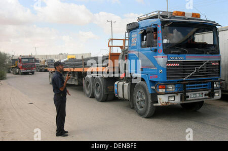 Sept. 22, 2013 - Rafah, Gaza Strip, Palestinian Territory - A Palestinian policeman stands near trucks loaded with cement supplies after upon arrival to the town of Rafah through the Kerem Shalom crossing between Israel and the southern Gaza September 22, 2013. Israel began allowing construction material for private projects into the Gaza Strip on Sunday for the first time in six years, in response to a request from Palestinian President Mahmoud Abbas, an Israeli defence official said  (Credit Image: © Eyad Al Baba/APA Images/ZUMAPRESS.com) Stock Photo