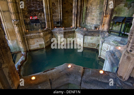 St.Winefride's Well,a holy site where a spring brings water from the hillside for bathing by a devout oriental man.a Wales UK Stock Photo