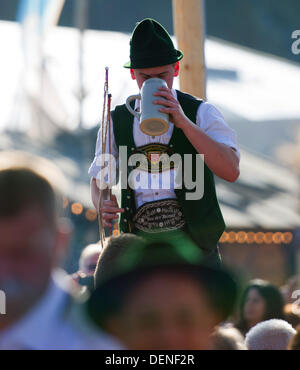 Munich, Germany. 21st Sep, 2013. A young man a so-called 'Goasslschnalzer' drinks from a mug of a beer tent on the opening day of the 180th Oktoberfest at the Theresienwiese in Munich, Germany, 21 September 2013. The annual beer folk festival runs until 06 October. Photo: Inga Kjer/dpa/Alamy Live News Stock Photo