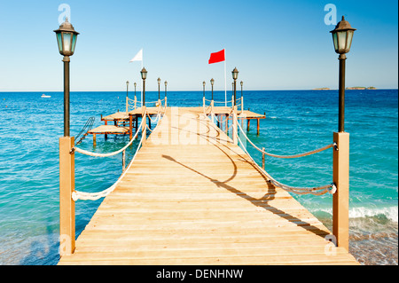 light poles and rope fence on wooden pier Stock Photo