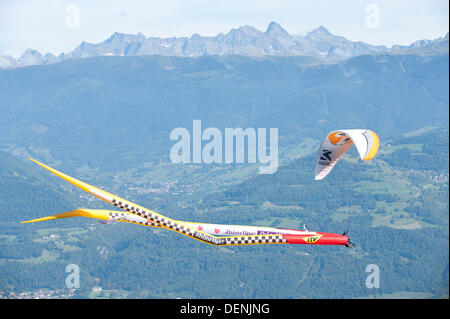 St Hilaire Du Touvet, France. 22nd Sep, 2013. On a perfect late summer day thousands of spectators flock to the spectacle of paraglider pilots taking off from an alpine cliff face dressed up in elaborate fancy dress. Photo credit: Graham M. Lawrence/Alamy Live News. Stock Photo