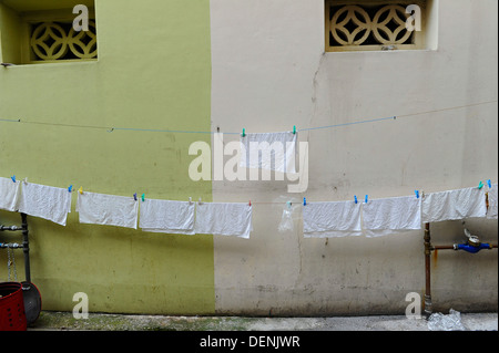 White tea towels hanging on a rope washing line. Stock Photo