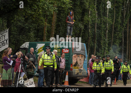 Balcombe, West Sussex, UK. 22nd Sep, 2013. Environmentalist gets good view as Police change shift at 'Belt it out Balcombe 3 event' outside Cuadrilla site entrance. .  The anti fracking environmentalists are protesting against test drilling by Cuadrilla on the site in West Sussex that could lead to the controversial fracking process. Credit:  David Burr/Alamy Live News Stock Photo