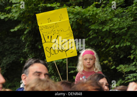 Balcombe, West Sussex, UK. 22nd Sep, 2013. Pretty young face in the crowd with solar sign at 'Belt it out at Balcombe 3' event outside the Cuadrilla site.   The anti fracking environmentalists are protesting against test drilling by Cuadrilla on the site in West Sussex that could lead to the controversial fracking process. Credit:  David Burr/Alamy Live News Stock Photo