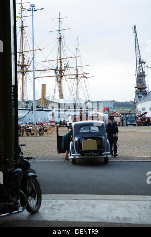 Chatham, UK. 21st Sep, 2013. Salute to the 40's - Britain's 1940's Home Front Event at The Historic Dockyard Chatham. Civilian vehicles, cranes, ships, docks. Stock Photo