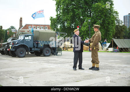 Chatham, UK. 21st Sep, 2013. Salute to the 40's - Britain's 1940's Home Front Event at The Historic Dockyard Chatham.  A member of the Home Front Guard shakes the hand of a 1940's soldier veteran. Credit:  Tony Farrugia/Alamy Live News Stock Photo