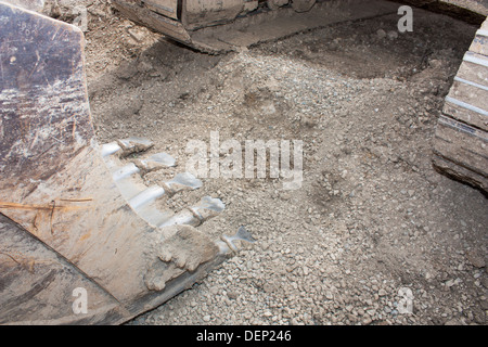 An excavator in the dirt on a construction job site. Stock Photo