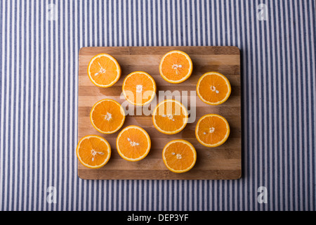 oranges on a wooden plate with blue white table runner Stock Photo