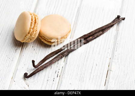 vanilla macaroons with vanilla pod on kitchen table Stock Photo