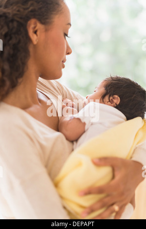 Hispanic mother holding infant son Stock Photo