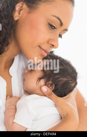 Hispanic mother holding infant son Stock Photo