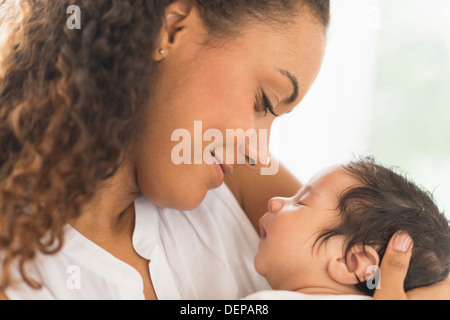 Hispanic mother holding infant son Stock Photo