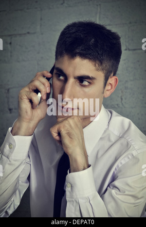 young businessman talking on phone in her office Stock Photo