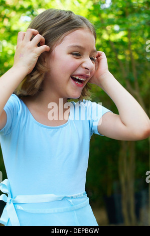 Hispanic girl laughing outdoors
